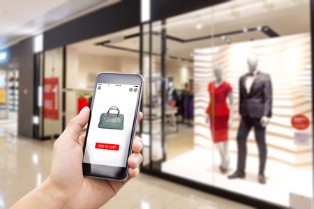 mobile phone with online shopping in modern fashion shopのeditorial素材