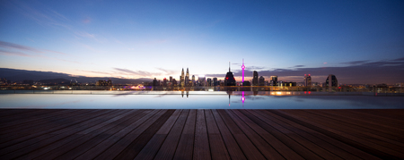 modern cityscape of kuala lumpur at twilight from swimming pool on balconyのeditorial素材
