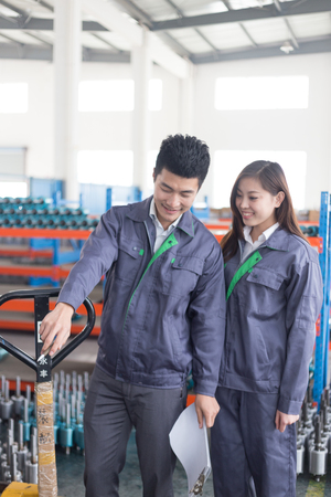 young chinese man and woman work in motor manufacturing factoryのeditorial素材