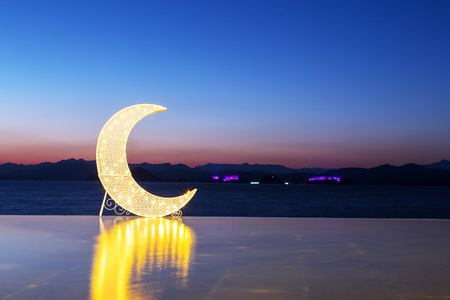 crescent moon shaped light on bank and night scene of hangzhou qiandao lakeのeditorial素材