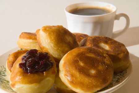 Pancakes lie on a dish. Behind a cup costs with coffeeの写真素材
