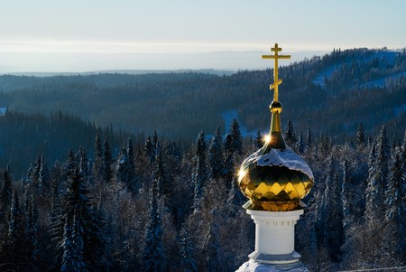 Golden dome orthodox church on background woodの写真素材