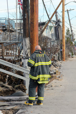 BREEZY POINT, NY - NOVEMBER 20: Firefighter assessing damage in hurricane devastated area  in the aftermath of Hurricane Sandy on November 20, 2012 in Breezy Point, NY. More than 80 houses were destroyed in out-of-control six-alarm blaze.のeditorial素材