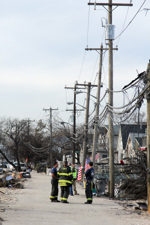 BREEZY POINT, NY - NOVEMBER 20: Firefighters assessing damage in hurricane devastated area  in the aftermath of Hurricane Sandy on November 20, 2012 in Breezy Point, NY. More than 80 houses were destroyed in out-of-control six-alarm blaze.のeditorial素材