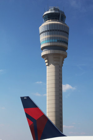 ATLANTA, GEORGIA - AUGUST 27: Delta plane next to Air Traffic Control Tower at Atlanta Hartsfield-Jackson Airport on  August 27, 2012 in Atlanta, Georgia.のeditorial素材