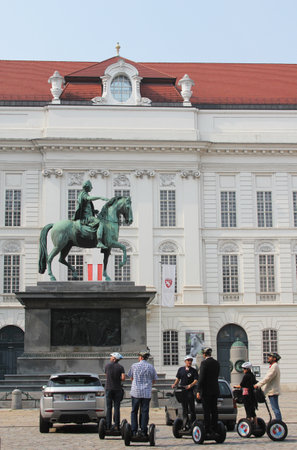 VIENNA, AUSTRIA - SEPTEMBER 3: Segway tour excursion in front of statue of Joseph II on Josefplatz square on September 3, 2012 in Vienna. Statue created by sculptor Franz Anton Zauner in17951806のeditorial素材