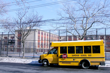 BROOKLYN, NEW YORK - FEBRUARY 14: School bus in front of public school in Brooklyn, NY on February 14, 2013. NYC School Bus Drivers union 1181 still on strike form January 16, 2013.のeditorial素材