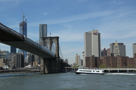NEW YORK - APRIL 30: New York Waterway ferry under Brooklyn Bridge on April 30, 2013. NY Waterway running ferry and bus service in the Port of New York and New Jersey and in the Hudson Valleyのeditorial素材
