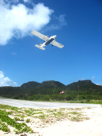 ST. BARTHS, FRENCH WEST INDIES - JANUARY 21:Small plane taking off from St  Barths airport on January 23, 2006. At 2,133 ft its runway is one of the shortest in the world.のeditorial素材