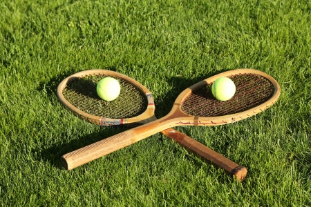 Old tennis rackets on grass courtの写真素材