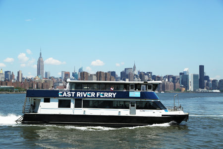 NEW YORK - June 20: East River ferry boat rides in Midtown Manhattan on June 20, 2013. East River Ferry features service that connects Manhattan with various destinations in Brooklyn and  Queens のeditorial素材