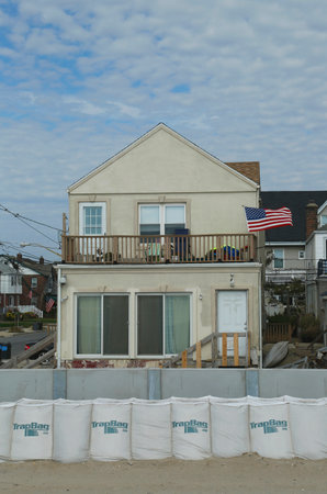 FAR ROCKAWAY, NY - OCTOBER 22  Damaged beach house in devastated area one year after Hurricane Sandy on October 22, 2013 in Far Rockaway, NY  Notice protective barrier build to prevent floodingのeditorial素材