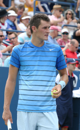   NEW YORK - AUGUST 26  Professional tennis player Bernard Tomic during first round match at US Open 2013 against Albert Ramos at National Tennis Center on August 26, 2013 in New Yorkのeditorial素材