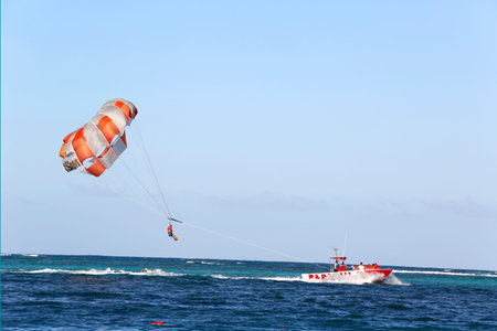 PUNTA CANA, DOMINICAN REPUBLIC - JANUARY 3  Parasailing in a blue sky in Punta Cana on January 3, 2014  Parasailing is a popular recreational activity among tourists in Dominican Republic のeditorial素材