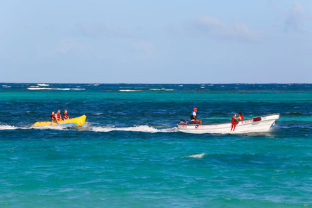 PUNTA CANA, DOMINICAN REPUBLIC - DECEMBER 31  Banana boat riding at the Bavaro Beach in Punta Cana on December 31, 2013  The Dominican Republic is the most visited destination in the Caribbean のeditorial素材