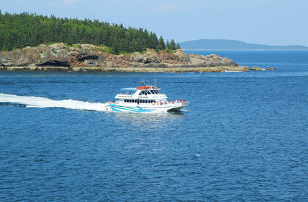 BAR HARBOR, MAINE - JULY 5 Lighthouse tours boat at the Frenchman Bay in Acadia National Park on July 5, 2013  Acadia National Park reserves much of Mount Desert Island, and associated smaller islandsのeditorial素材