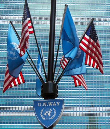 NEW YORK CITY - MARCH 20  United Nations and United States Flags in the front of UN Headquarter in New York on March 20, 2014のeditorial素材