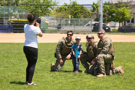 FREEPORT, NEW YORK - MAY 25 Unidentified US Navy s from EOD team taking picture with spectator after mine countermeasures demonstration during Fleet Week 2014 in Long Island on May 25, 2014のeditorial素材