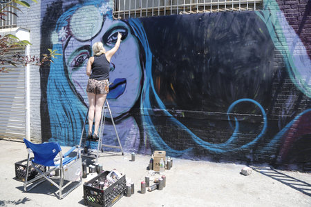 NEW YORK - JUNE 1  Street artist painting mural at Williamsburg in Brooklyn on June 1, 2014  Outdoor art gallery known as the Bushwick Collective has most diverse collection of street art in Brooklyn のeditorial素材