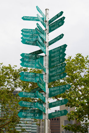 NEW YORK - JUNE 24  The Signs of Paradise signpost installation in Battery Park on June 24, 2014  It shows direction and distance to towns with name Paradise located in all 50 states のeditorial素材