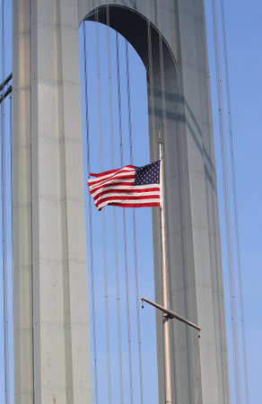 NEW YORK - JULY 1  American flag in the front of Verrazano Bridge in Staten Island on July 1, 2014のeditorial素材