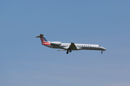 NEW YORK - JULY 10  American Eagle Embraer ERJ-145 in New York sky before landing at JFK Airport on...