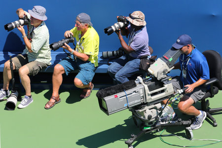 NEW YORK - AUGUST 25 Professional photographers and TV camera man at  US Open 2014 at Billie Jean King National Tennis Center on August 25, 2014 in New Yorkのeditorial素材