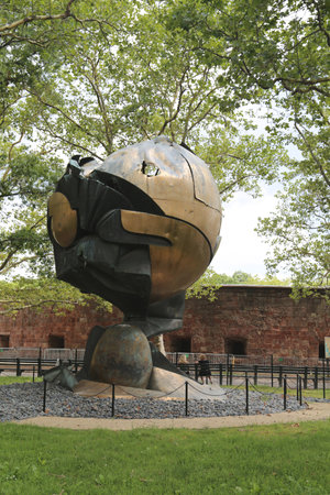 NEW YORK - JUNE 17: World Trade Center Sphere damaged at September 11 in Battery Park on June 17, 2014. Eternal flame in front of it was ignited on September 11, 2002のeditorial素材