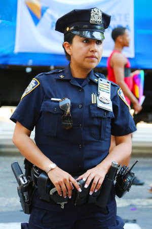 NEW YORK - June 29: NYPD officer providing security during LGBT Pride Parade in NY on June 29, 2014. LGBT pride march takes place during pride week and is the culmination of week long festivitiesのeditorial素材