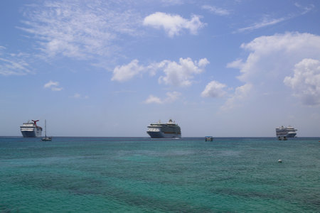 GRAND CAYMAN - JUNE 11:Three Cruise Ships anchors at the Port of George Town, Grand Cayman on June 11, 2014. George Town, Grand Cayman, is the capital of the Cayman Islands, in the British West Indiesのeditorial素材