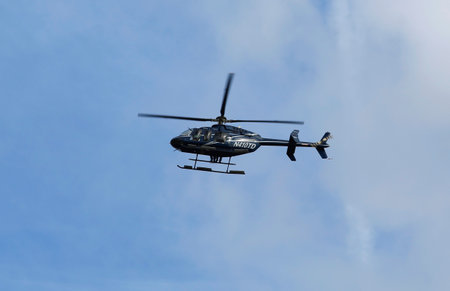 NEW YORK - NOVEMBER 2: Bell 407 helicopter in the sky during New York City Marathon start on November 2, 2014 in Brooklyn.  The Bell 407 is a four-blade, single-engine, civil utility helicopterのeditorial素材