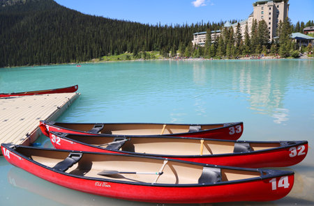 LAKE LOUISE, CANADA - JULY 27:Canoes on beautiful turquoise Lake Louise on July 27, 2014. Lake Louise is the second most-visited destination in the Banff National Park.のeditorial素材