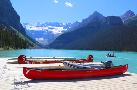 LAKE LOUISE, CANADA - JULY 27:Canoes on beautiful turquoise Lake Louise on July 27, 2014. Lake Louise is the second most-visited destination in the Banff National Park.のeditorial素材