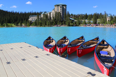 LAKE LOUISE, CANADA - JULY 27:Canoes on beautiful turquoise Lake Louise on July 27, 2014. Lake Louise is the second most-visited destination in the Banff National Park.のeditorial素材