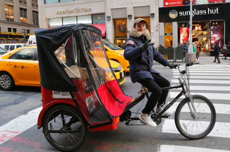 NEW YORK - DECEMBER 18: Unidentified bicycle rickshaw in Midtown Manhattan on December 18, 2014. Pedal taxi is another of many ways to get around New york city with pedal power.のeditorial素材