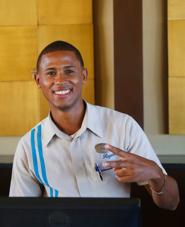 PUNTA CANA, DOMINICAN REPUBLIC - JANUARY 4, 2015: Unidentified front desk employee at Royalton All-inclusive Resort and Casino located at the Bavaro beach in Punta Canaのeditorial素材