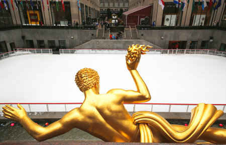 NEW YORK - FEBRUARY 26, 2015: Statue of Prometheus and ice-skating rink at the Lower Plaza of Rockefeller Center in Midtown Manhattan. Ice-skating began since Christmas Day in 1936のeditorial素材