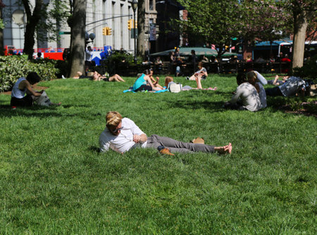 NEW YORK CITY - MAY 7, 2015: Locals and tourists crowded the Union Square Park in New York to enjoy the nice weather and take a sunbathのeditorial素材