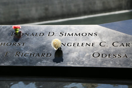 NEW YORK - JULY 11, 2015: Flowers left at the National September 11 Memorial at Ground Zero in Lower Manhattanのeditorial素材