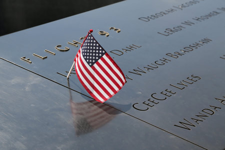NEW YORK - JULY 11, 2015: American flag left at the National September 11 Memorial  at Ground Zero...