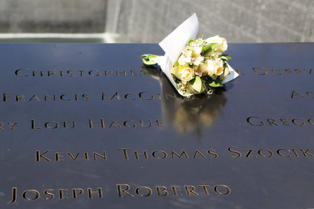 NEW YORK - JULY 11, 2015: Flowers left at the National September 11 Memorial at Ground Zero in Lower Manhattanのeditorial素材
