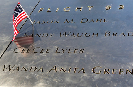 NEW YORK - JULY 11, 2015: American flag left at the National September 11 Memorial  at Ground Zero in Lower Manhattanのeditorial素材