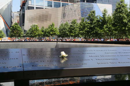 NEW YORK - JULY 11, 2015: Flower left at the National September 11 Memorial at Ground Zero in Lower Manhattanのeditorial素材