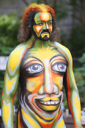 NEW YORK - JULY 18, 2015:Model during second NYC Body Painting Day in midtown Manhattan featuring artist Andy Golub in New York.Artists paint 100 fully nude models of all shapes and sizes during eventのeditorial素材