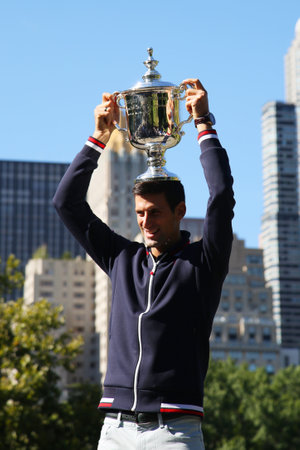 NEW YORK - SEPTEMBER 14, 2015: Ten times Grand Slam champion Novak Djokovic posing in Central Park with championship trophy after victory at US Open 2015のeditorial素材