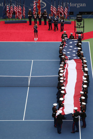 NEW YORK- SEPTEMBER 12, 2015: US Marine Corps unfurling American Flag during the opening ceremony of the US Open 2015 women s final at Billie Jean King National Tennis Center in New Yorkのeditorial素材