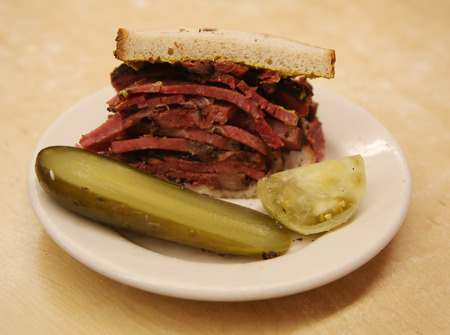 Famous Pastrami on rye sandwich served with pickle in New York Deliの写真素材