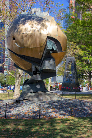 NEW YORK - SEPTEMBER  24, 2015: World Trade Center Sphere damaged at September 11 in Battery Park. Eternal flame in front of it was ignited on September 11, 2002のeditorial素材