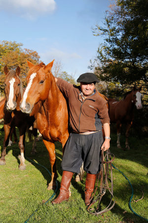 TORRES DEL PAINE, CHILE - APRIL 4, 2015: Gaucho in Torres del Paine National Park, Patagonia, Chile. Gaucho is a resident of the South American pampas, Gran Chaco, or Patagonian grasslandsのeditorial素材