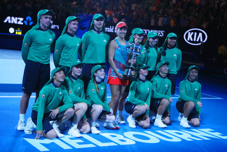MELBOURNE, AUSTRALIA - JANUARY 30, 2016: Grand Slam champion Angelique Kerber of Germany with ball boys holding Australian Open trophy during trophy presentation after victory at Australian Open 2016のeditorial素材